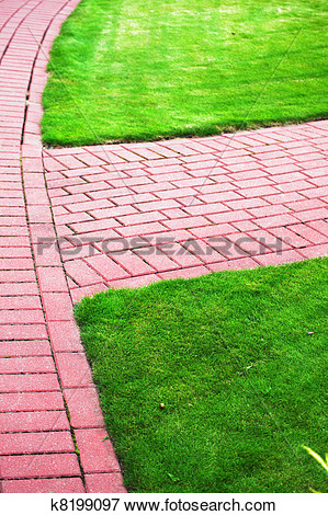Path With Grass Growing Up Between And Around Stones Brick Sidewalk