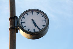 Big Old Clock At A Rusty Pole Against The Blue Sky Royalty Free Stock