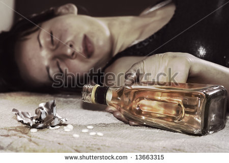 Dead Woman Lying On The Floor Bottle Of Whiskey In Her Hand And Pills    