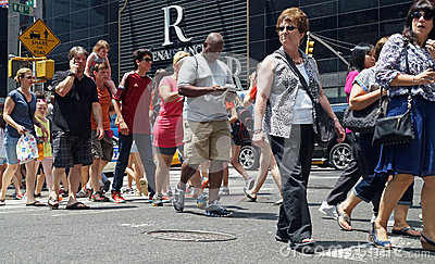 Phones Are Among A Diverse Crowd Of People Crossing A Busy Street In