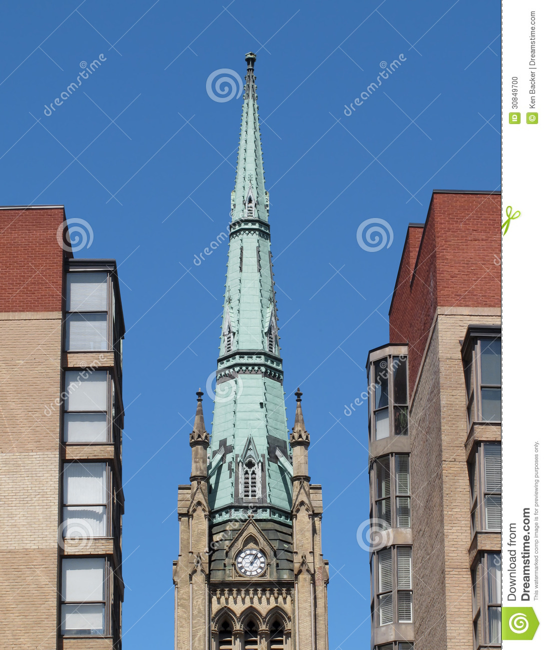 Old Tall And Steep Christian Church Steeple Spire Between Two Modern