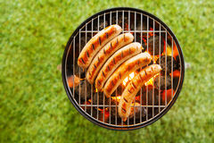 Beef Bratwurst Grilling Over A Barbecue Fire Stock Photo