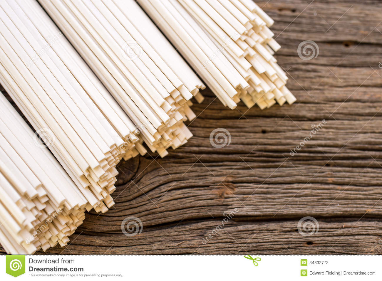 Border Of Asian Dry Noodle Bundles Over Rugged Wood Background 