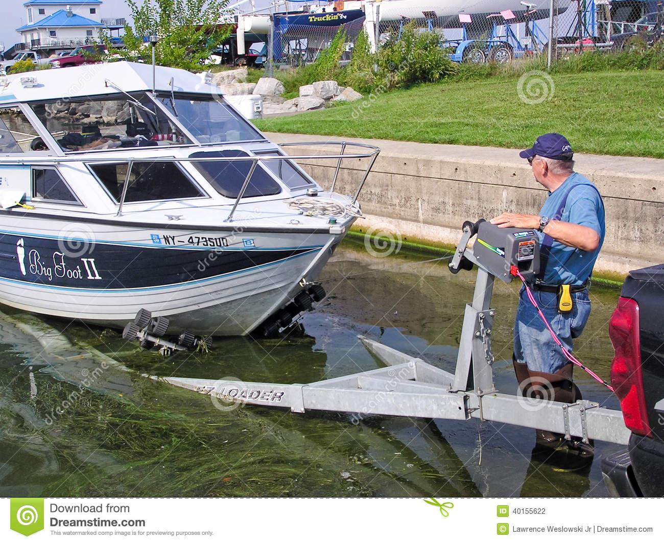 Man At A Boat Launch Loading His Boat Onto Its Trailer At The End Of    