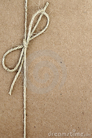 String Bow On Brown Paper Stock Photo   Image  22999590