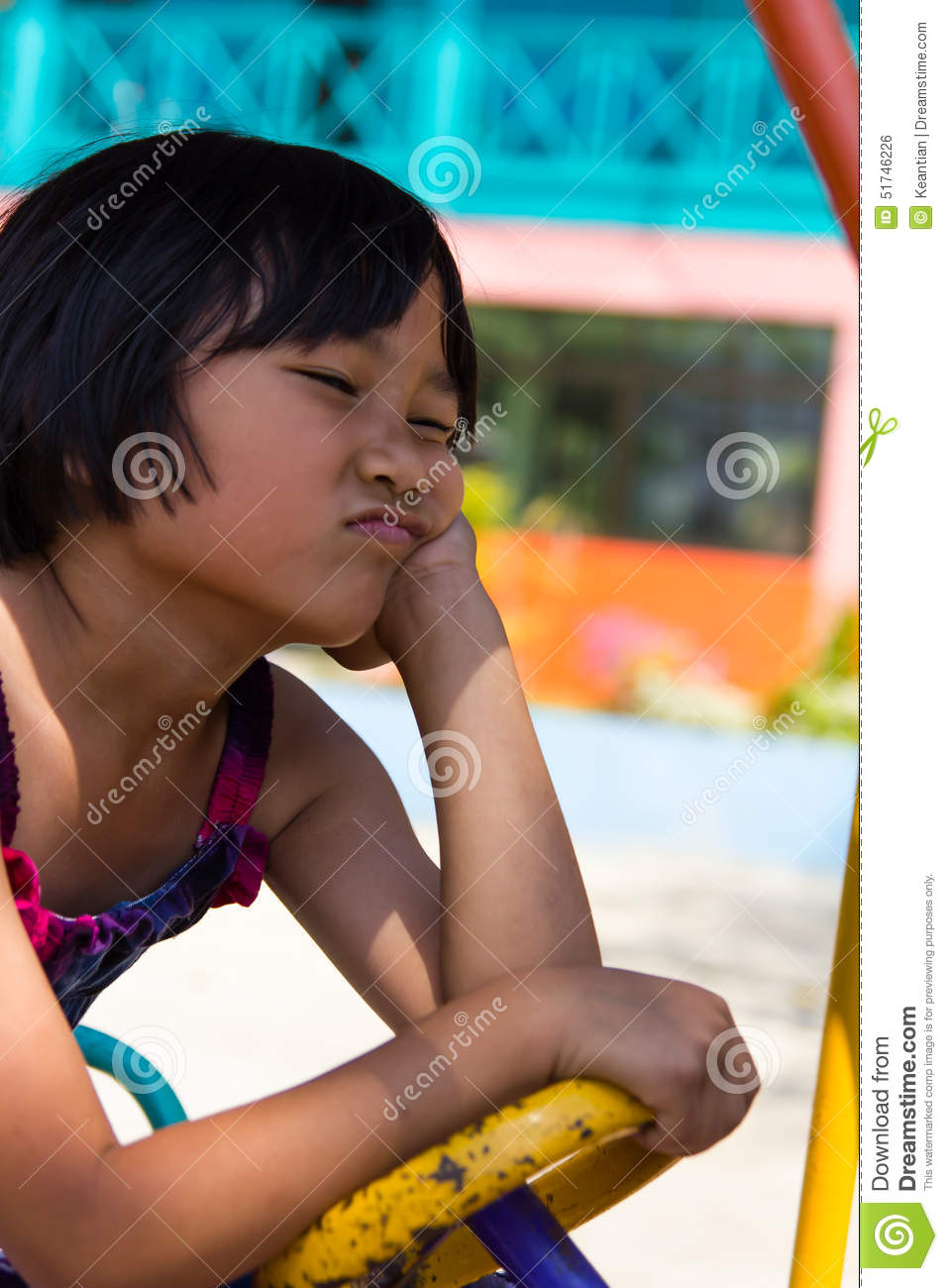 Girl Sitting On An Upset Scowl Driving School Playground In One Of
