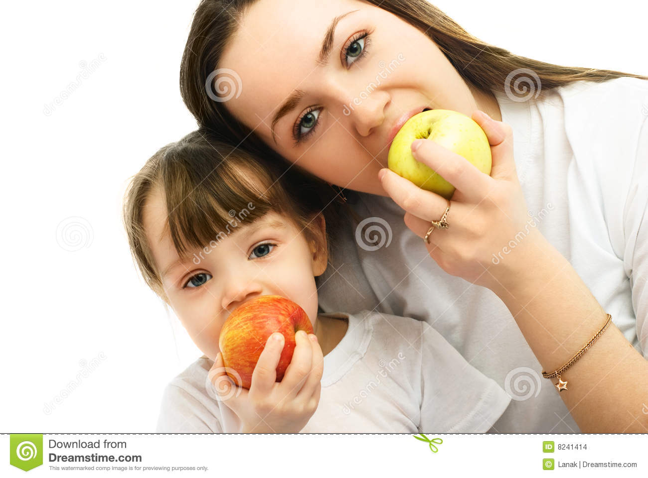 Portrait Of A Young Mother And Her Little Daughter Eating Apples
