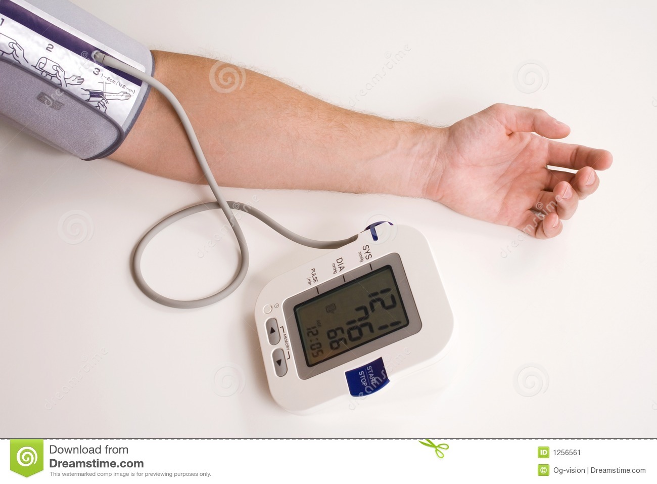 Man Taking His Blood Pressure Using An Electronic Blood Pressure    