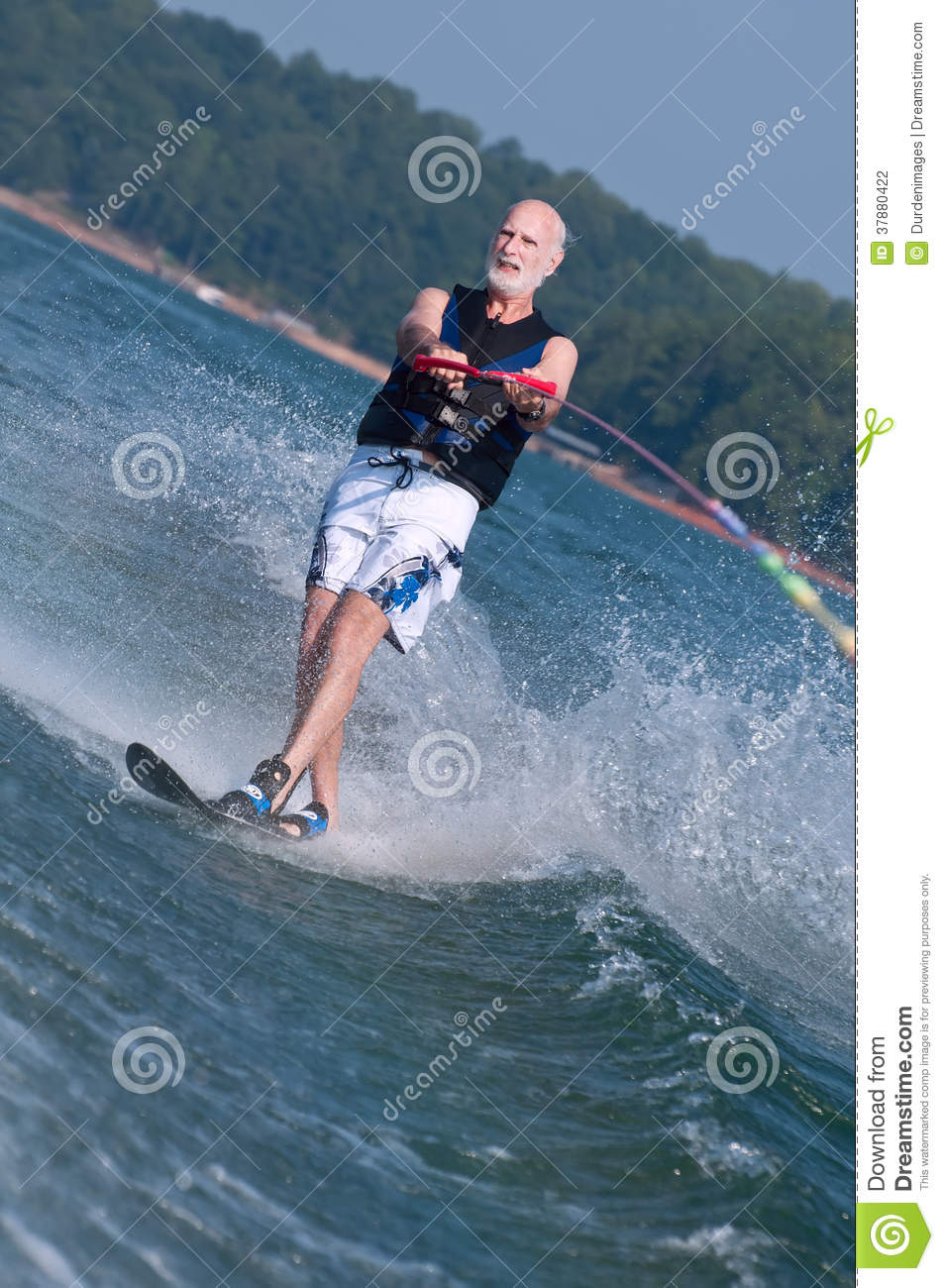 Waterski As He Carves Through The Boat Wake Creating Copious Spray