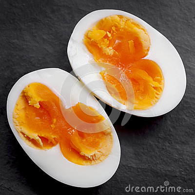 Hard Boiled Egg With Double Yolk Sliced Open  Overhead View On Black