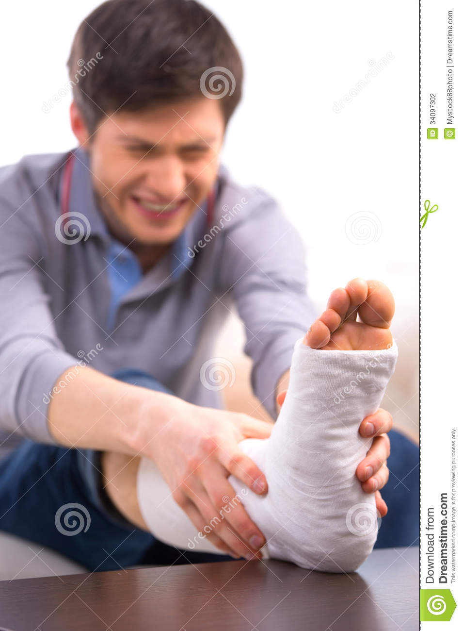 Man Is Suffering In Pain While Touching Broken Leg