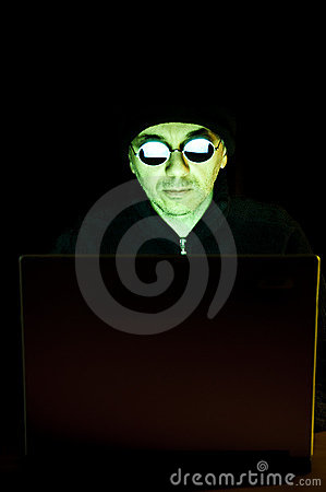 Male Hacker Wearing Mirror Glasses Working On A Laptop Computer