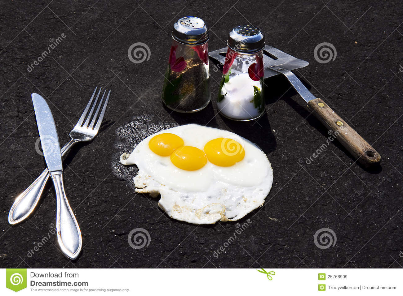 Concept Of Frying Eggs On Hot Sizzling Summer Day On Asphalt Driveway