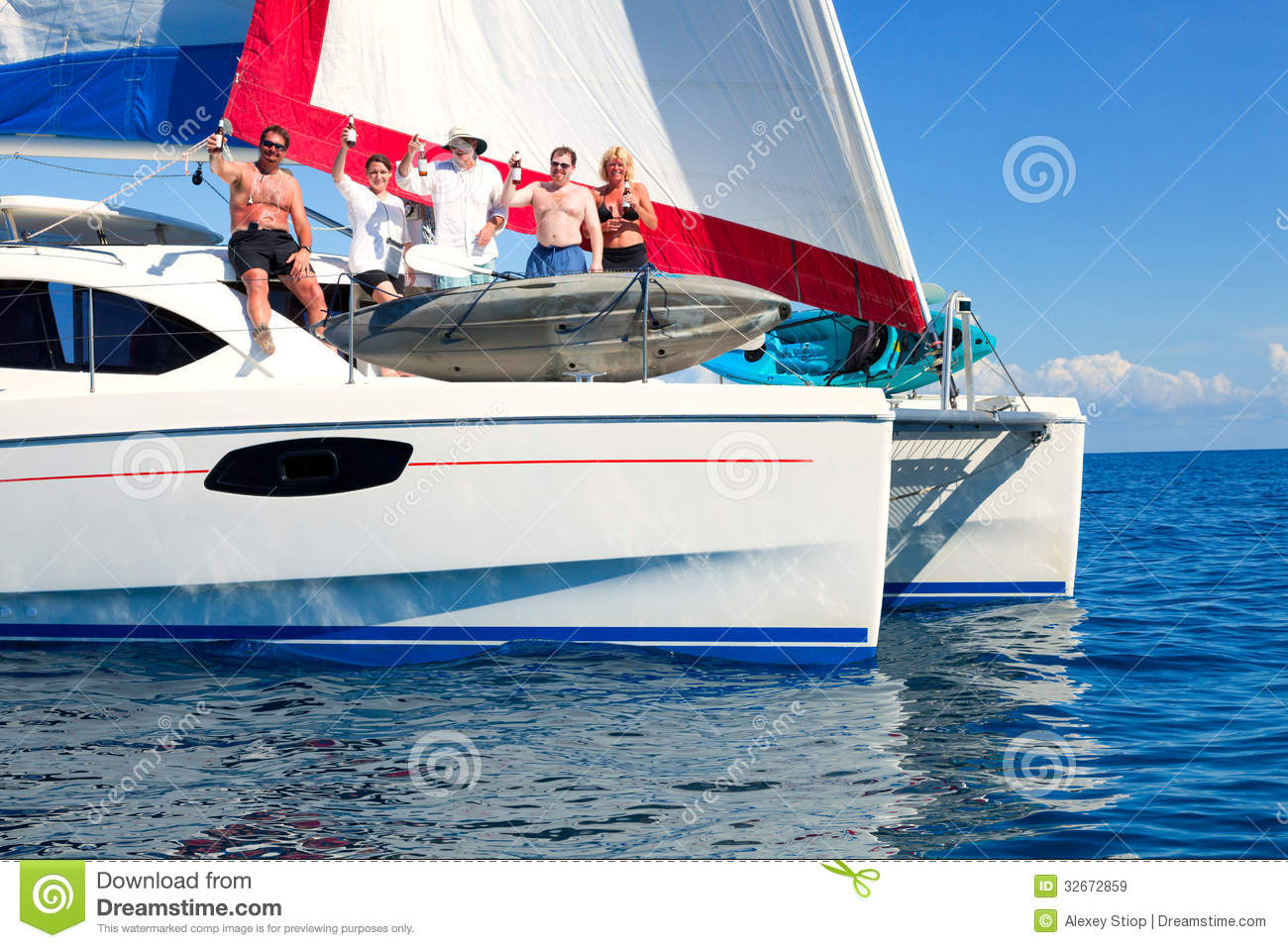 Sailboat In The Open Sea With Sailing Crew Partying On The Deck 