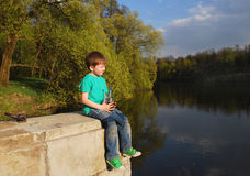 The Boy On The River Drinking Water Royalty Free Stock Photography