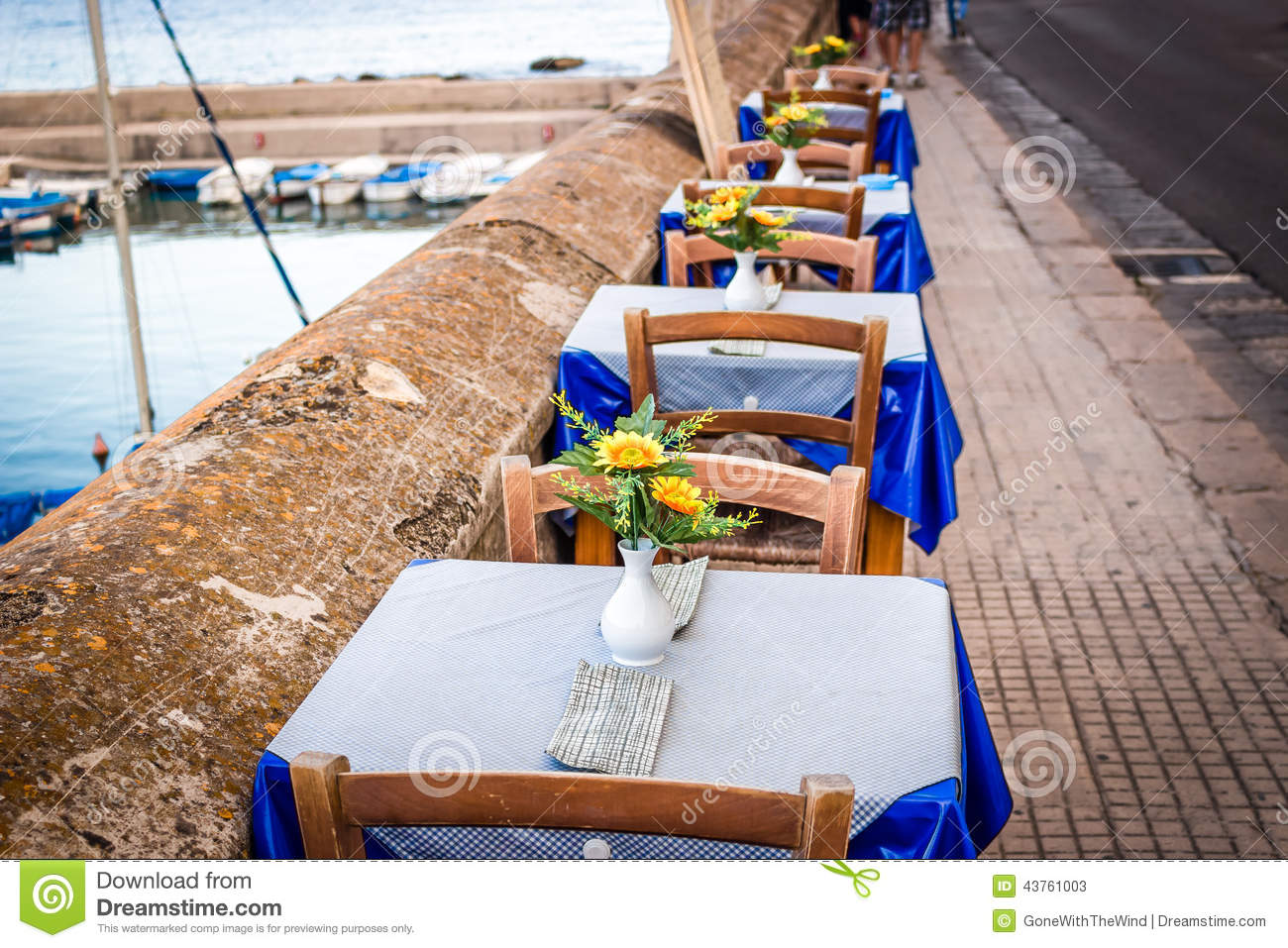 Dinner Tables In Italian Restaurant On Brown Stone Parapet On The Sea    