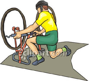 Bike Racer Fixing His Bike   Royalty Free Clipart Picture