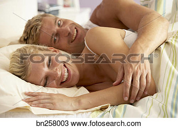 Stock Photo   Couple Cuddling In Bed  Fotosearch   Search Stock Images