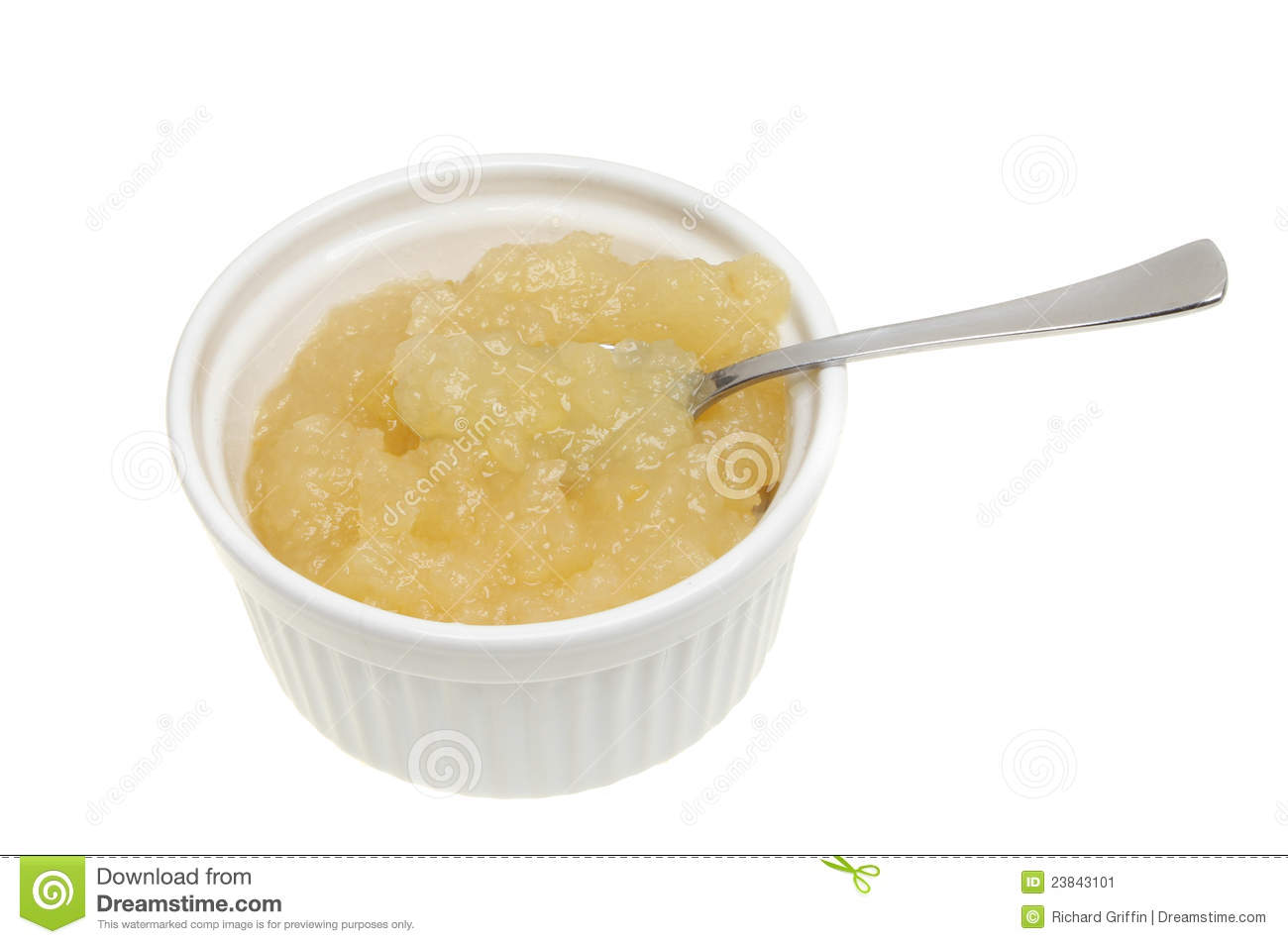 Apple Sauce With A Spoon In A Ramekin Isolated Against White