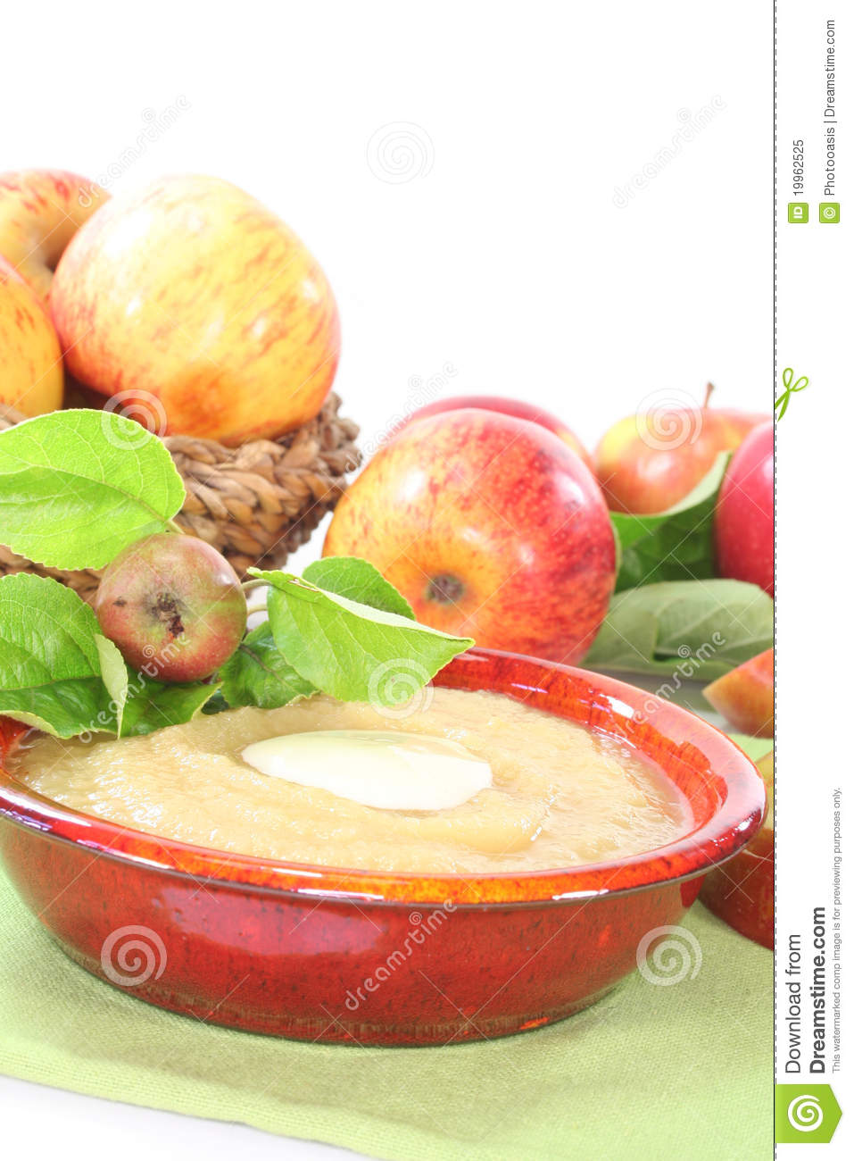 Apple Sauce With Vanilla Sauce And Fresh Apple With Leaves On A White