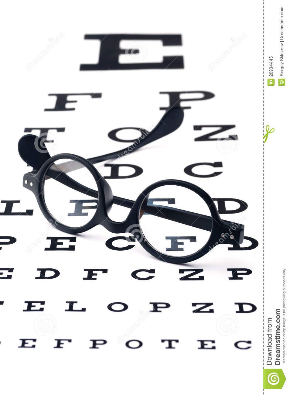 Fashioned Round Black Eyeglasses Lying Over The Eye Checking Chart