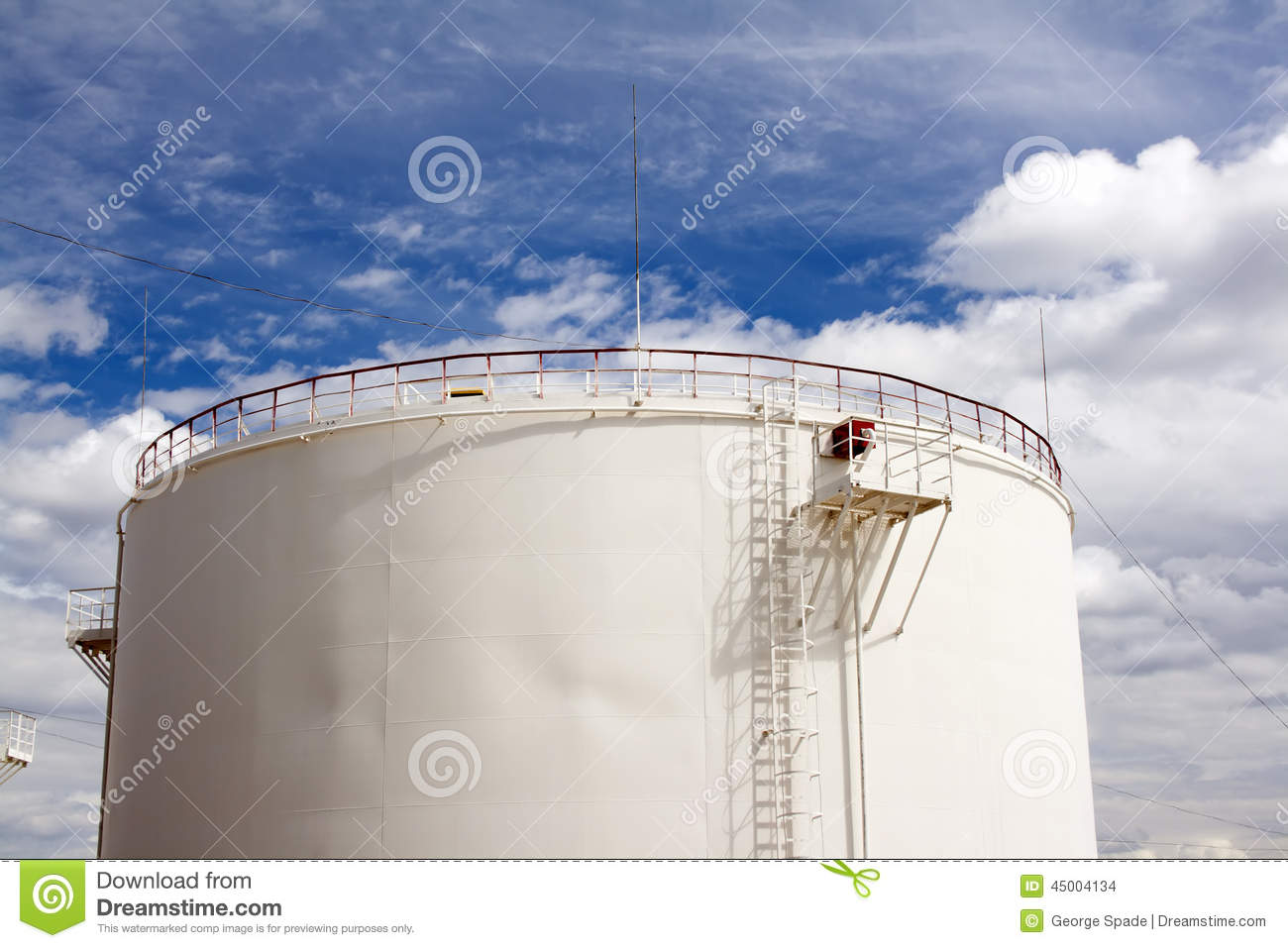 Oil Reservoir And Blue Sky With Clouds  Oil Industry And Gas Refinery