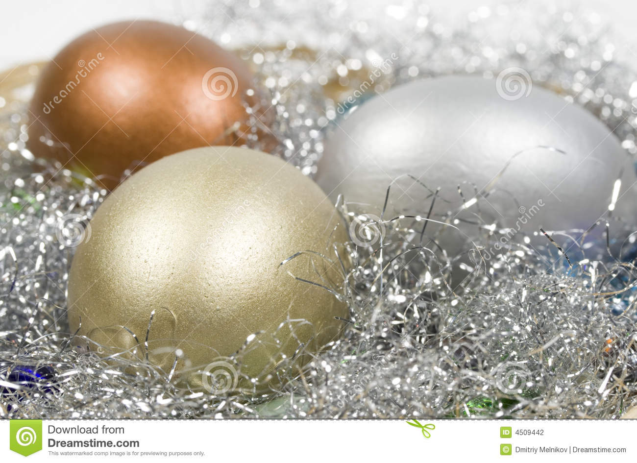 Gold Silver And Bronze Eggs In A Basket With A Glass Stones  Close Up