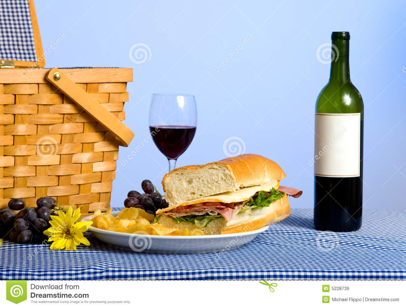 Picnic Lunch Consisting Of A Sandwich Potato Chips And Grapes On A    