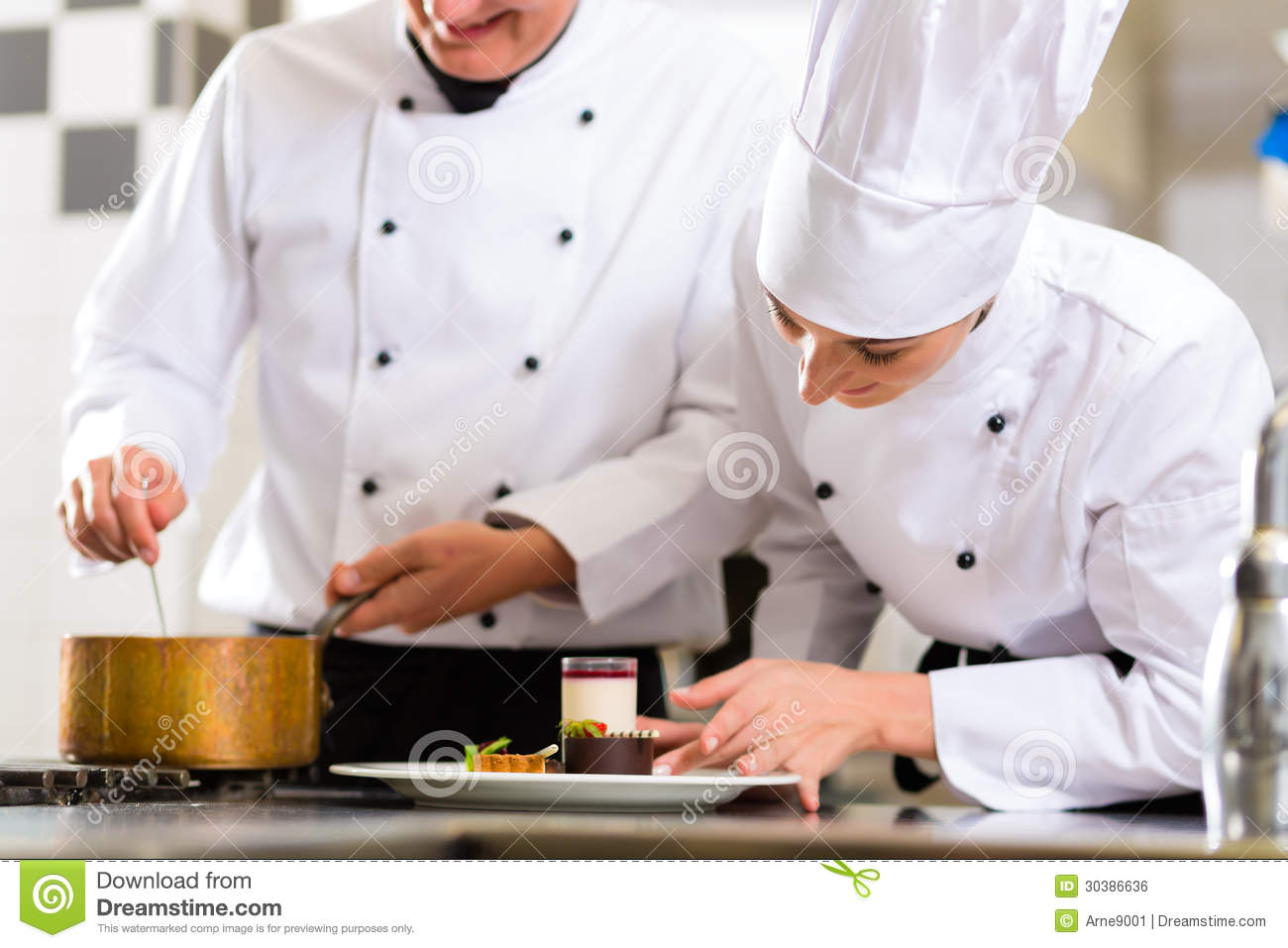 Chef Team In Restaurant Kitchen With Dessert Royalty Free Stock Image