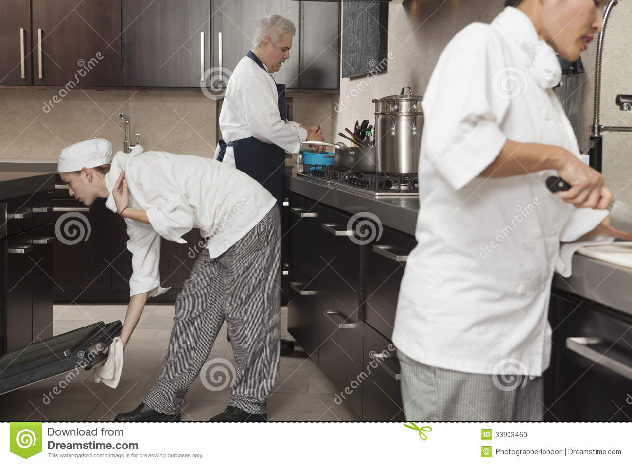 Chefs Working Together In Commercial Kitchen Stock Photo   Image    