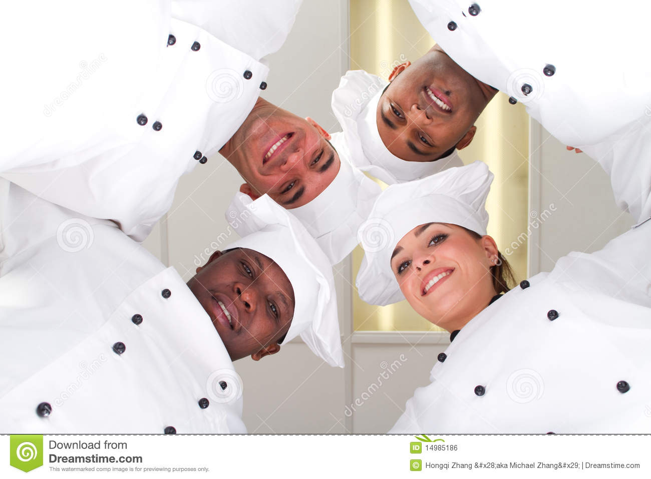 Four Happy Young Diverse Professional Chef In A Huddle