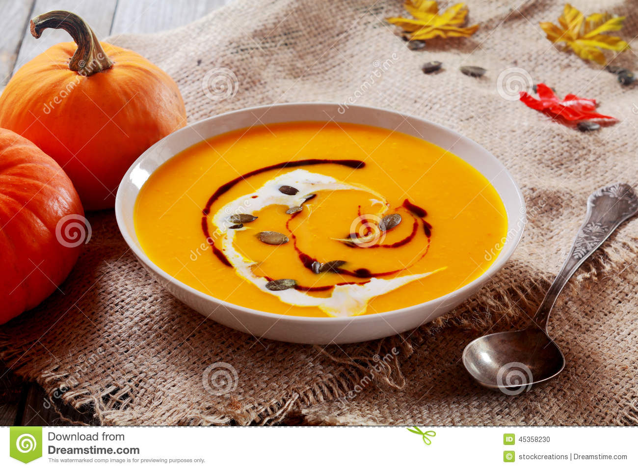 Or Fall Pumpkin Soup Garnished With Cream And Pumpkin Pips On Rustic    