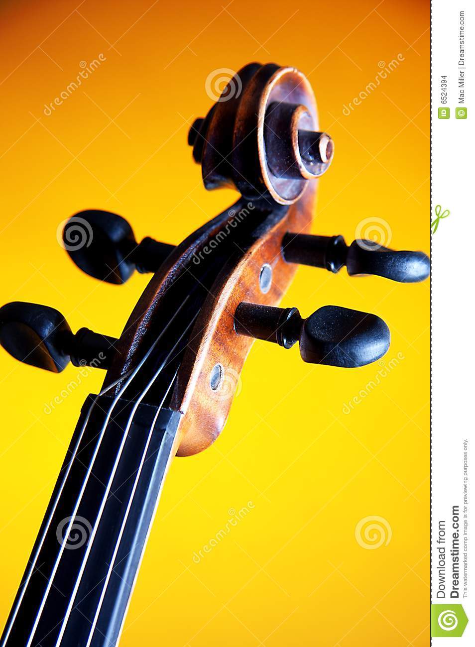 Violin Scroll And F Hole Isolated Against A Yellow Background In The