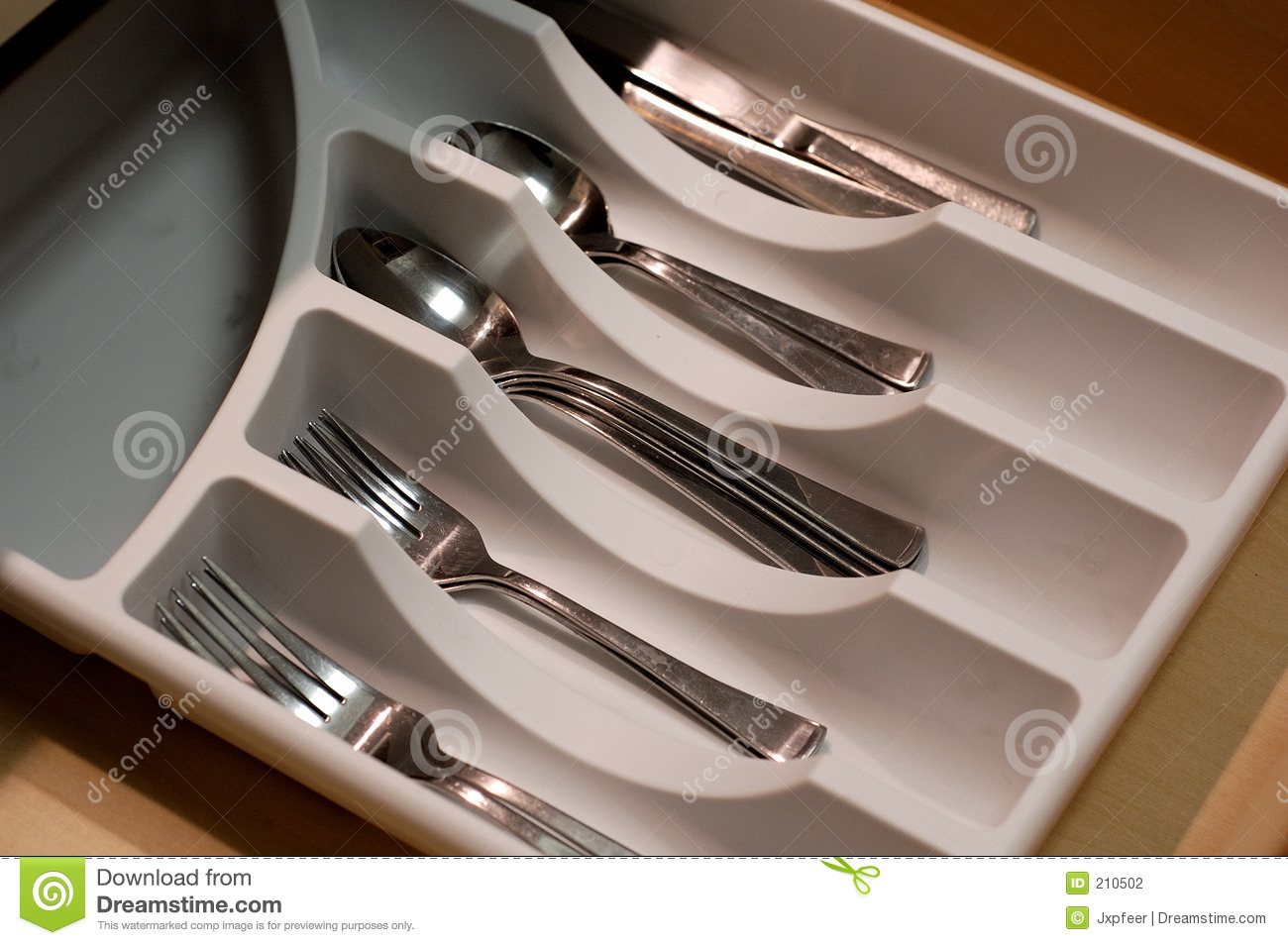 An Organize Kitchen Drawer With Forks Spoons And Knives In It 