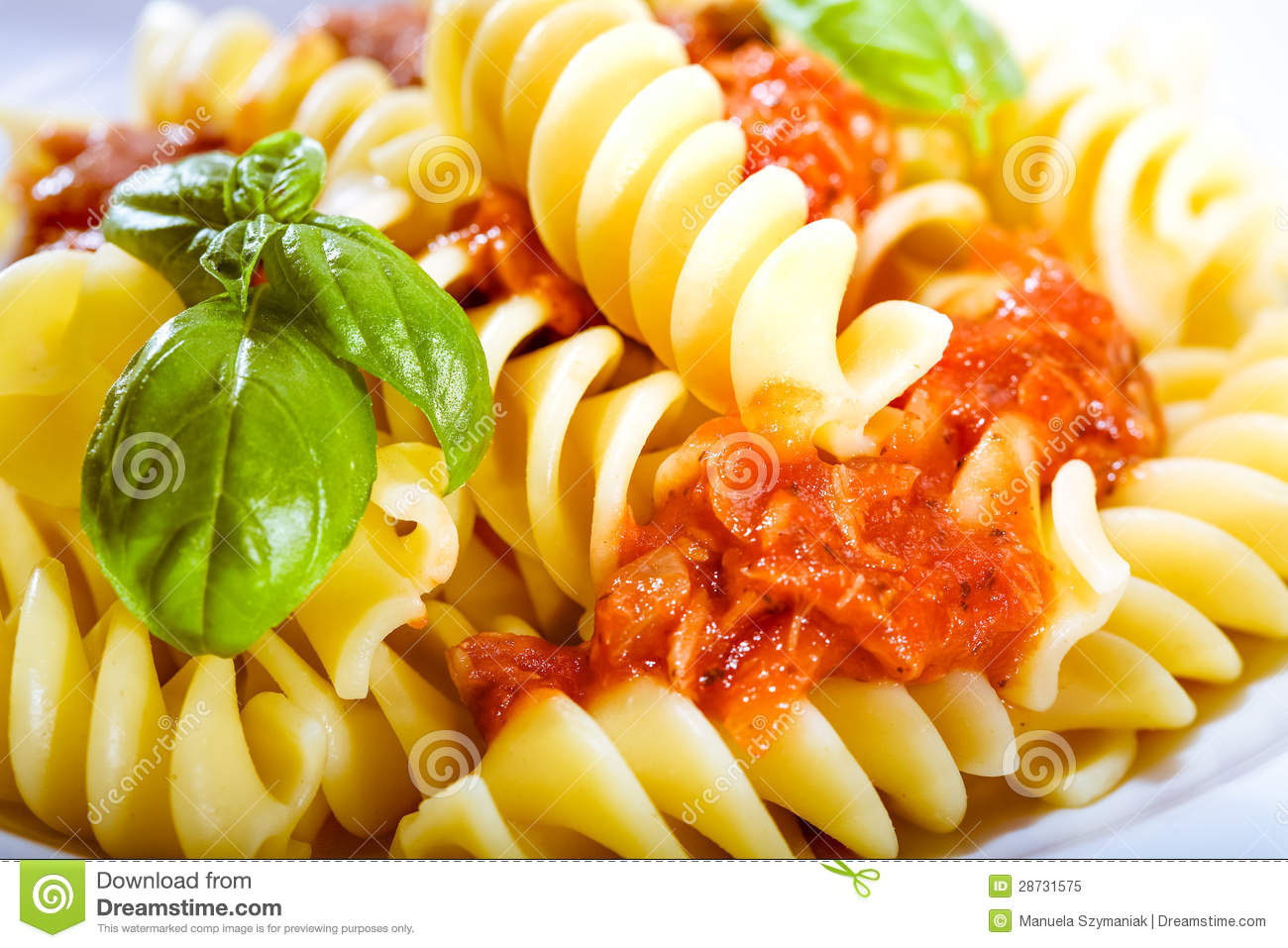 Closeup Of Fresh Spiral Italian Noodles Served With Pesto Sauce And