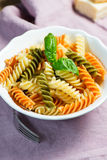 Spiral Pasta And Basil In Bowl Stock Photos