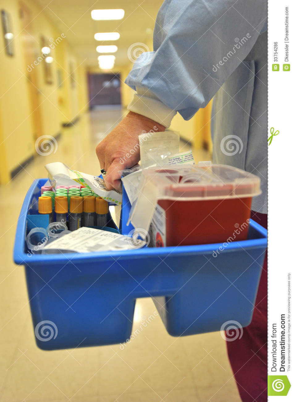 Lab Technician Carrying Tray To Patients Room To Take A Blood Sample    