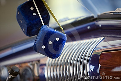 Blue Fuzzy Dice Hanging From A Vintage Car S Mirror 