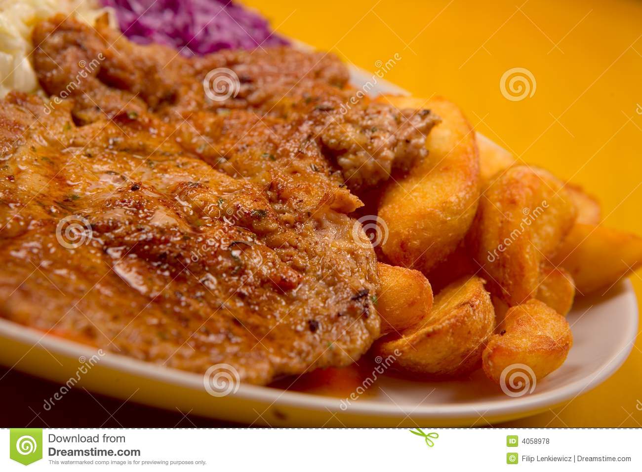 Grilled Steak And Potatoes With Red Cabbage On White Plate On Yellow    