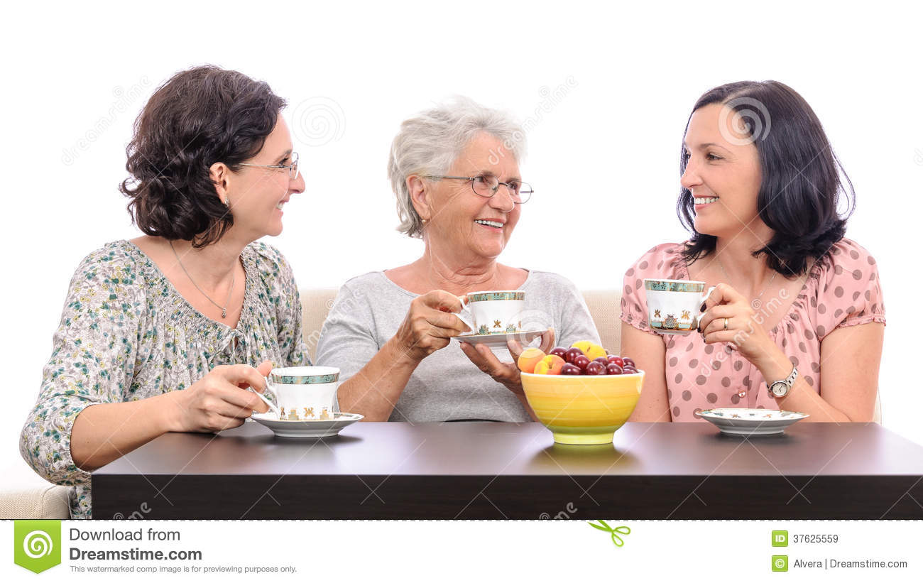 Group Of Women One Senior And Two Adult Ladies Talking Over A Cup Of    