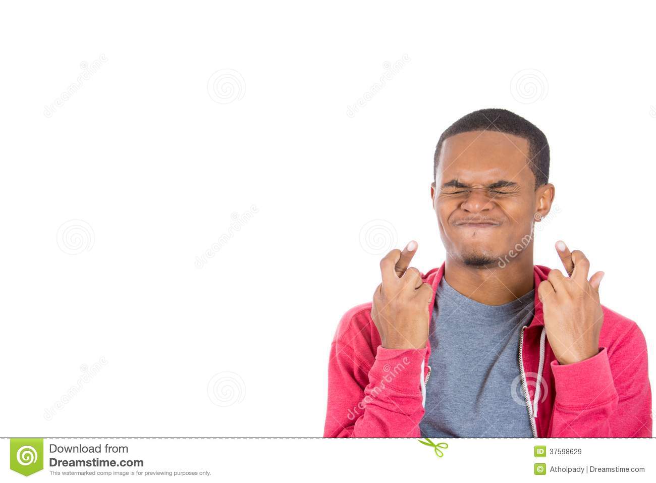 Closeup Portrait Of A Young Handsome Man Crossing Fingers Wishing And    