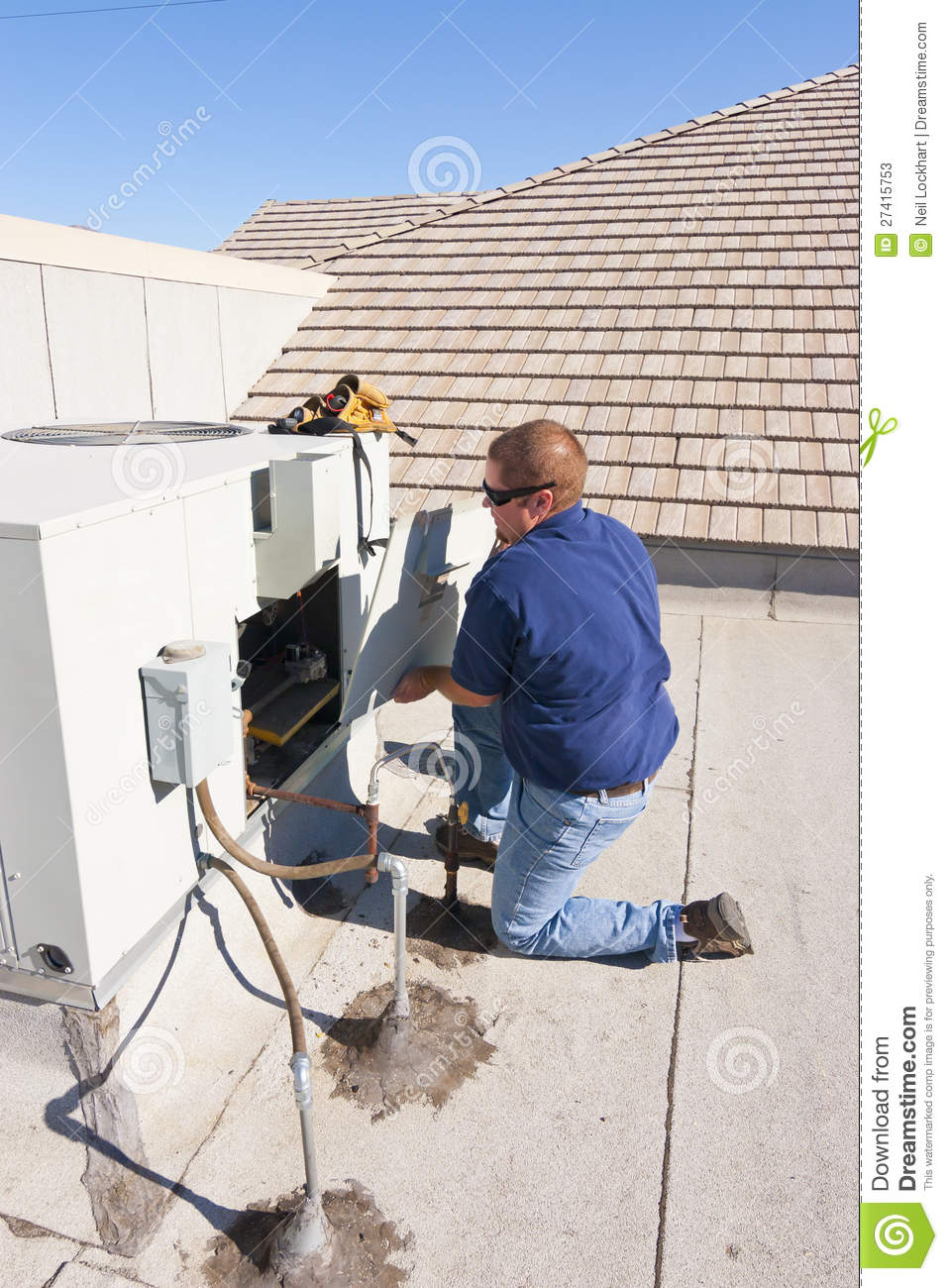 Air Conditioner Repair Man Accessing Unit On Rooftop By Removing Panel    
