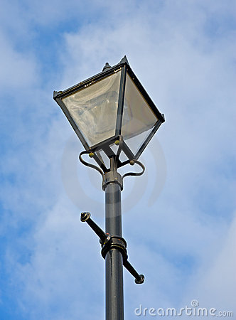 An Image Of An Old Fashioned Lamp Seen Against A Blue Cloudy Sky