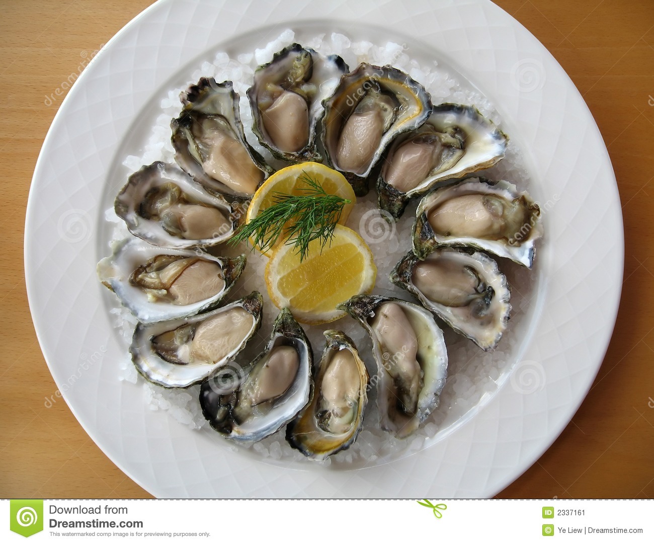 Dozen Of Fresh Natural Oysters Presented On Sea Salt With Slices Of
