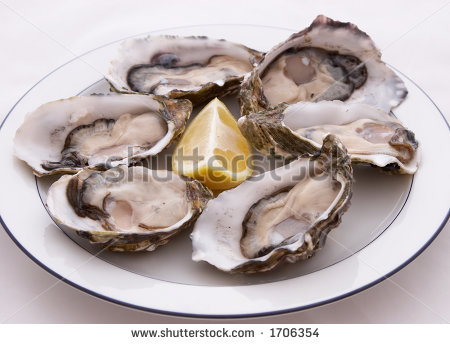 Half A Dozen Oysters On A Plate With A Lemon   Stock Photo