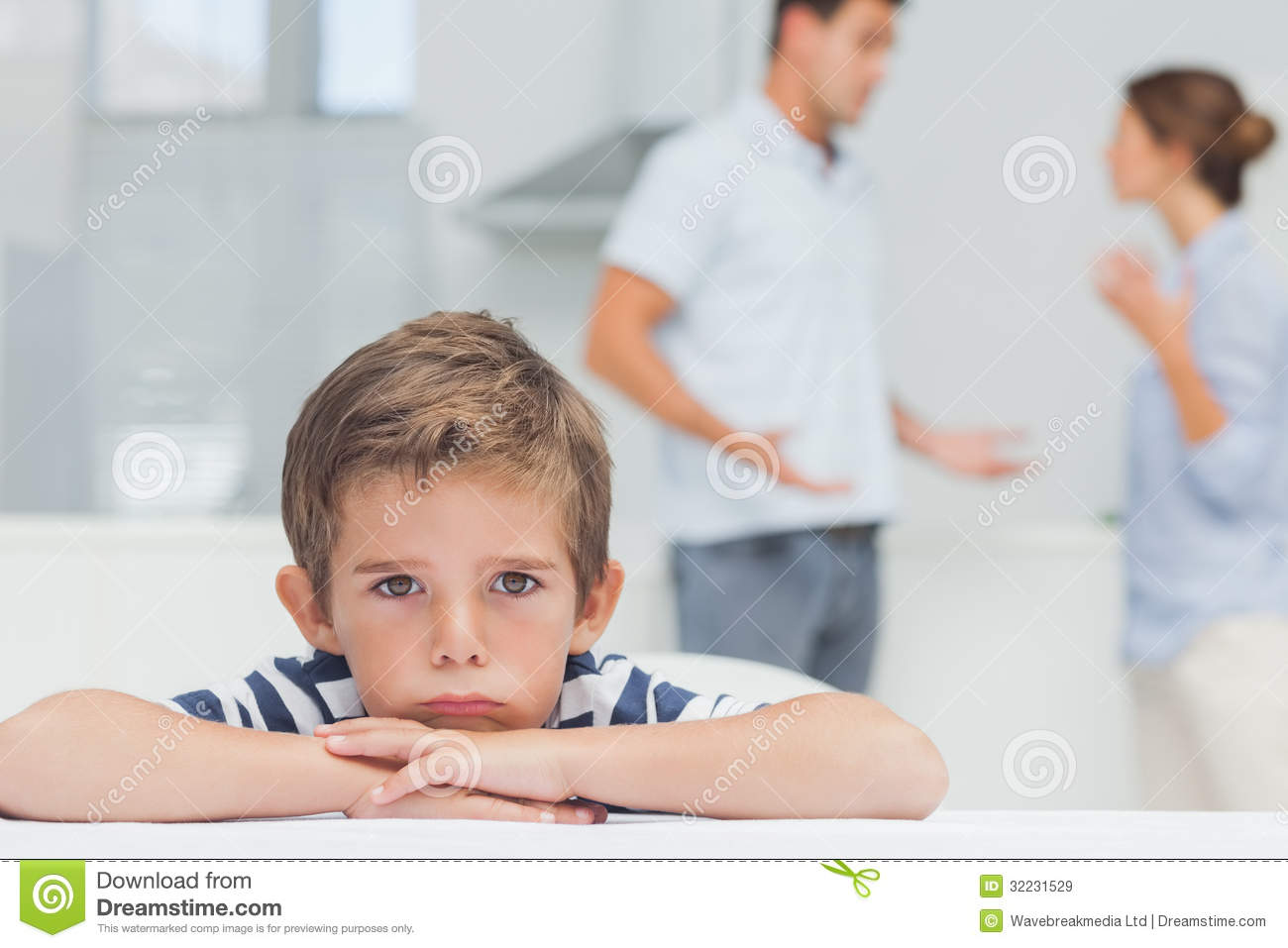Sad Boy With Arms Folded While Parents Quarreling Royalty Free Stock