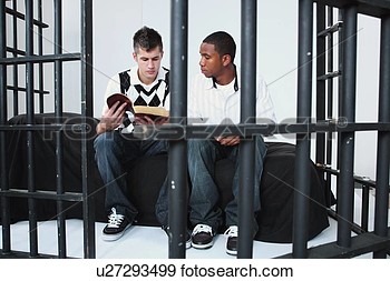 Stock Photograph Of A Young Man Reading The Bible To Another Young Man    