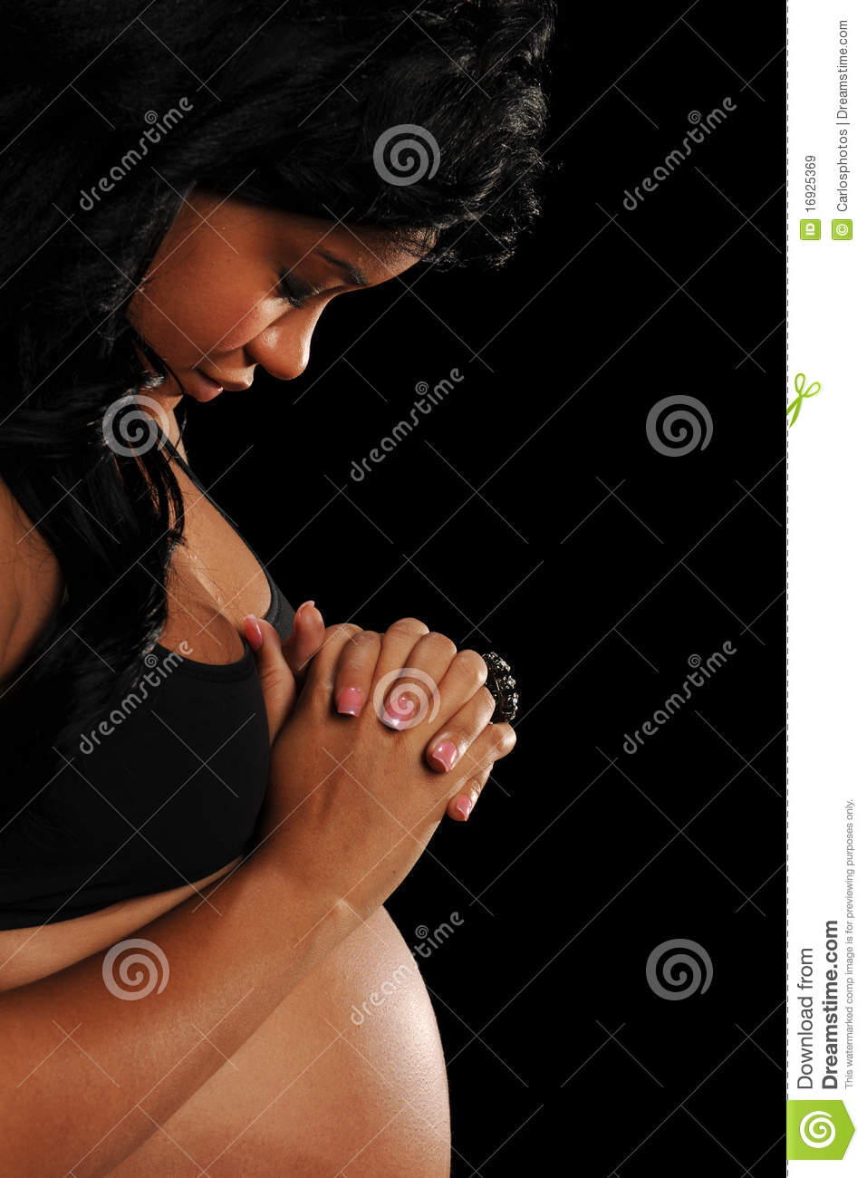 Young African American Woman Pregnant Praying Isolated On A Black
