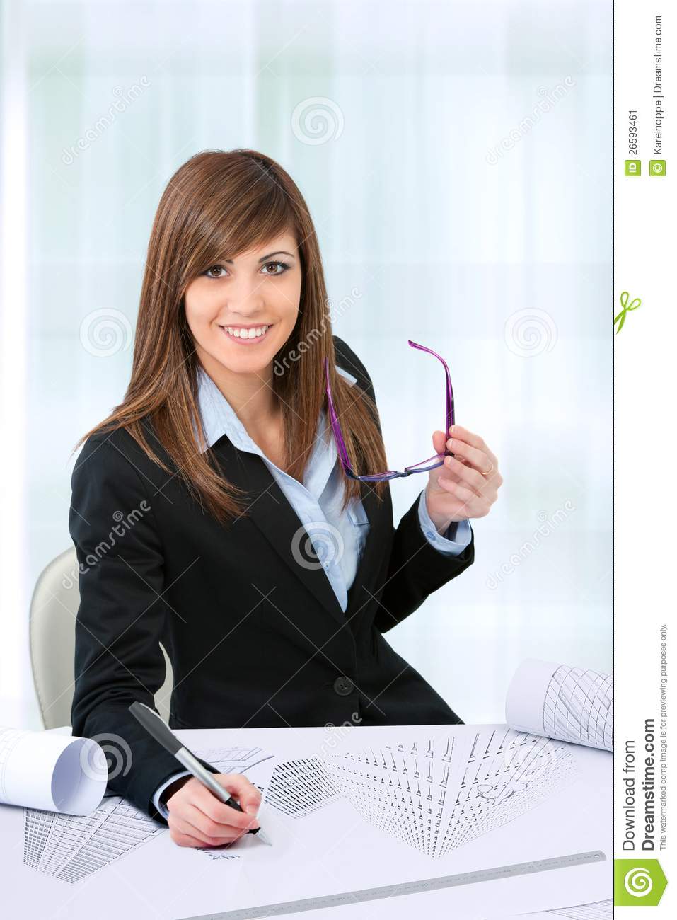 Attractive Young Female Office Worker At Desk In Office 