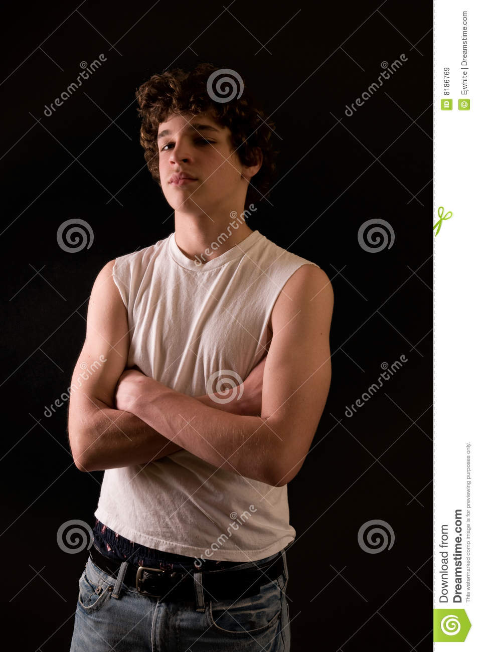 Portrait Of Athletic 13 Year Old Boy With Arms Crossed Looking Defiant